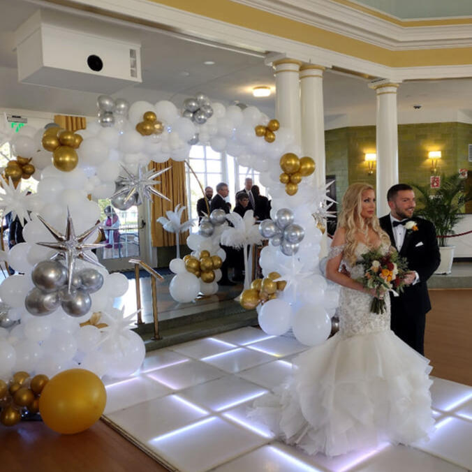 White, gold, and silver wedding arch by Amanda